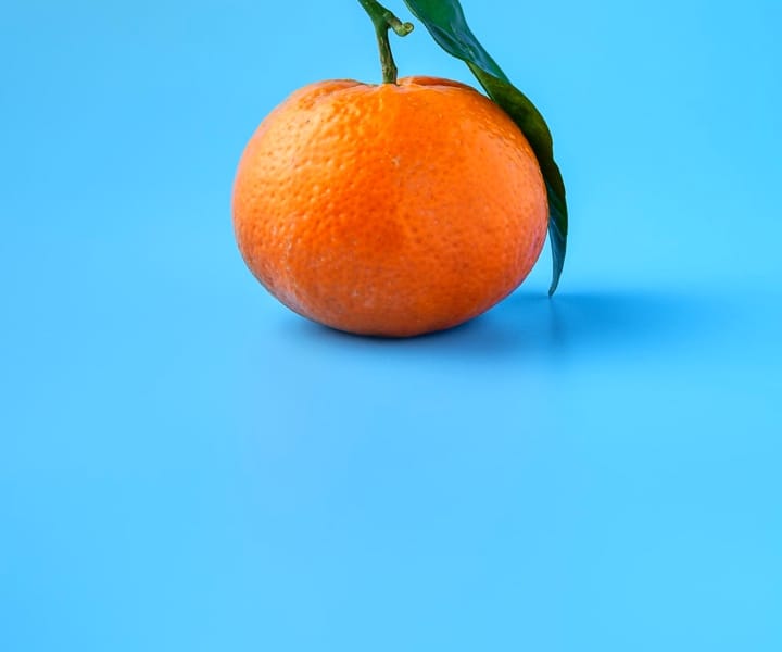 A cherry with a green background