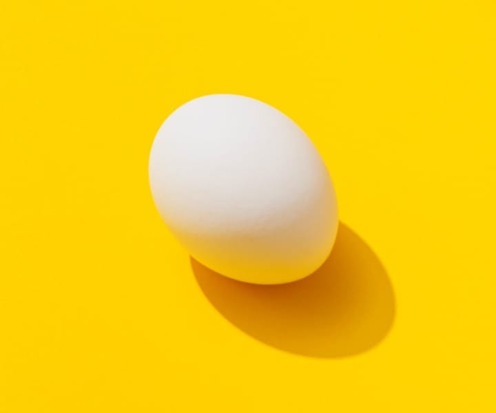 An egg with a yellow background